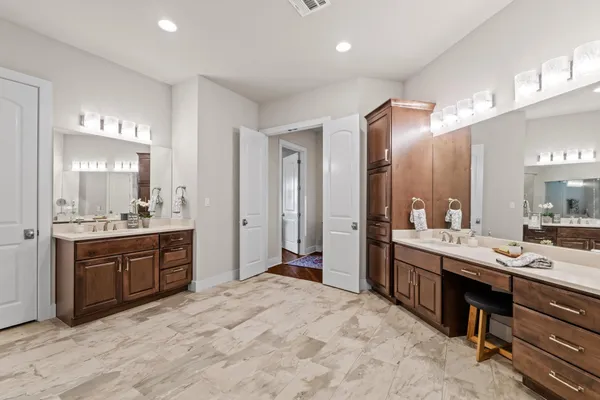a bathroom with mirror sink and glass door