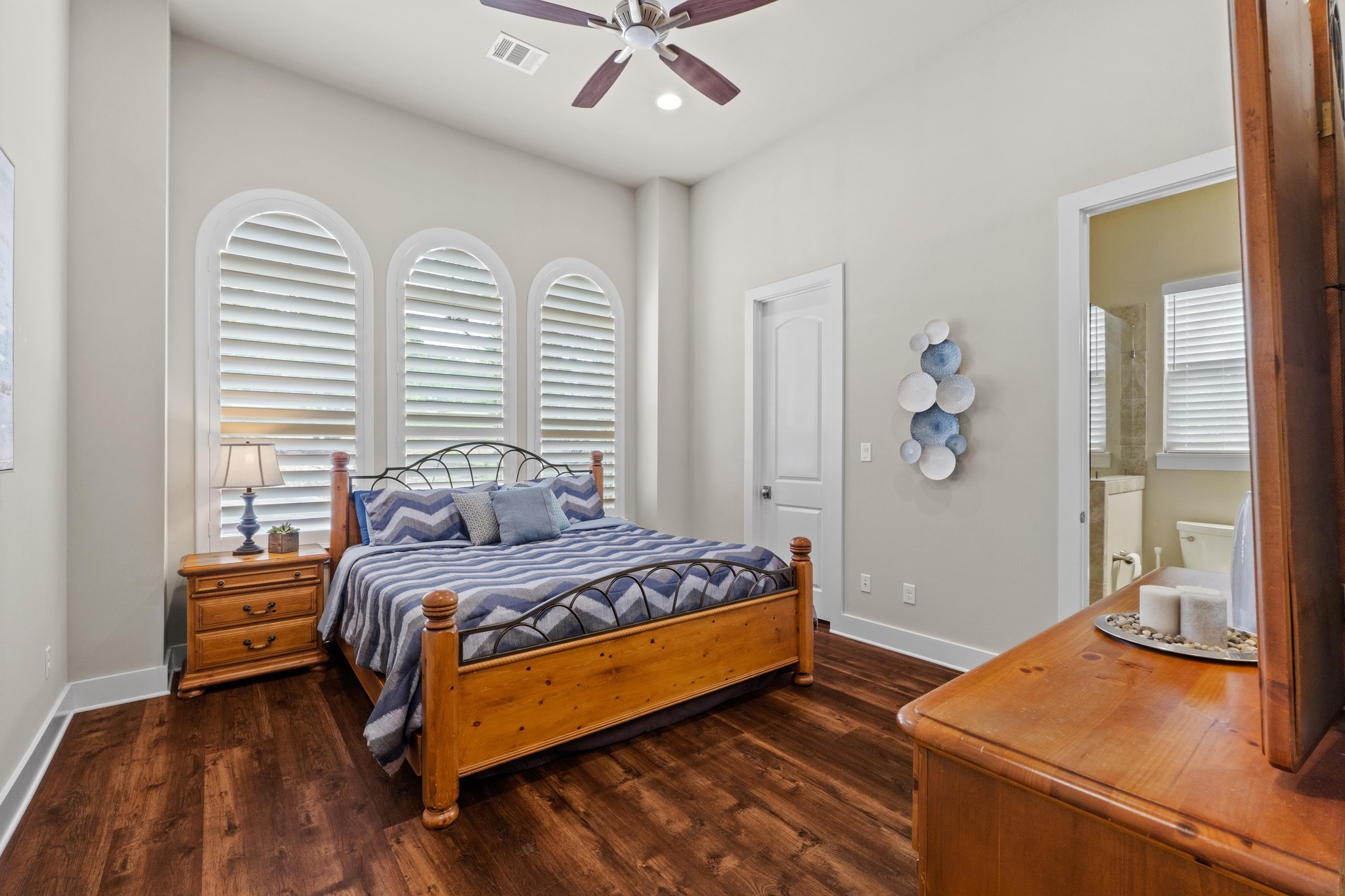 18817 Hidden Ridge Place Jonestown, TX 78645 - Photo 20 of 40 a bedroom with a bed and wooden floor