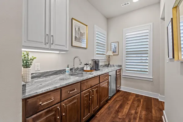 a bathroom with a granite countertop sink toilet a mirror and shower