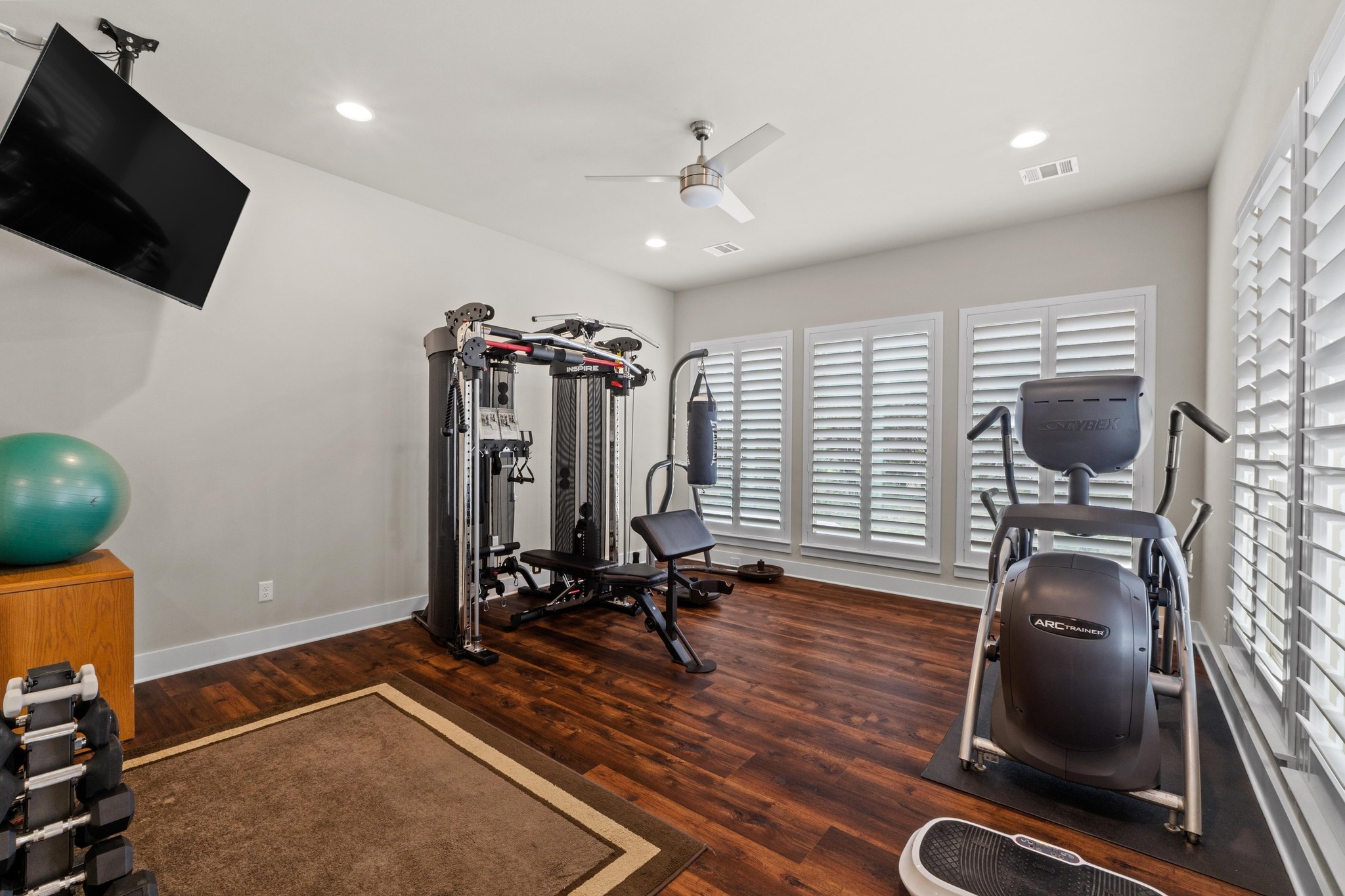 18817 Hidden Ridge Place Jonestown, TX 78645 - Photo 25 of 40 Exercise room featuring wood finished floors, visible vents, a ceiling fan, and a wealth of natural light