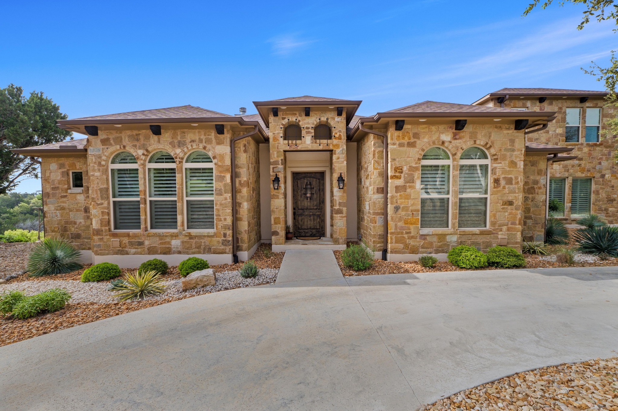 18817 Hidden Ridge Place Jonestown, TX 78645 - Photo 3 of 40 front view of a brick house with a small yard