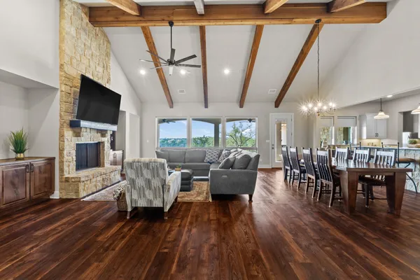 a living room with fireplace furniture and a wooden floor