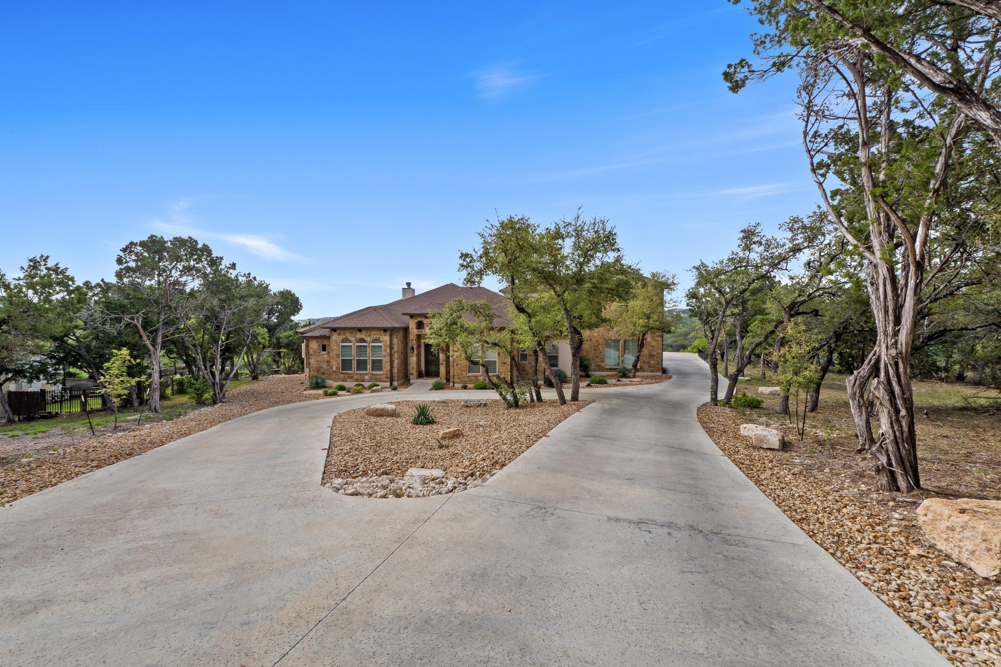 18817 Hidden Ridge Place Jonestown, TX 78645 - Photo 5 of 40 View of front of house with a chimney and curved driveway
