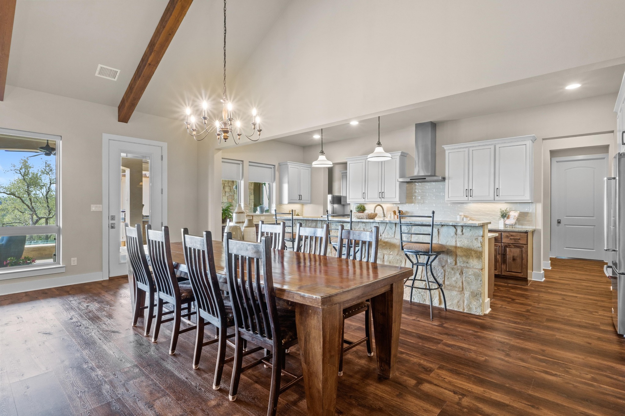 18817 Hidden Ridge Place Jonestown, TX 78645 - Photo 10 of 40 Dining room featuring beamed ceiling, a notable chandelier, dark wood-type flooring, visible vents, and recessed lighting