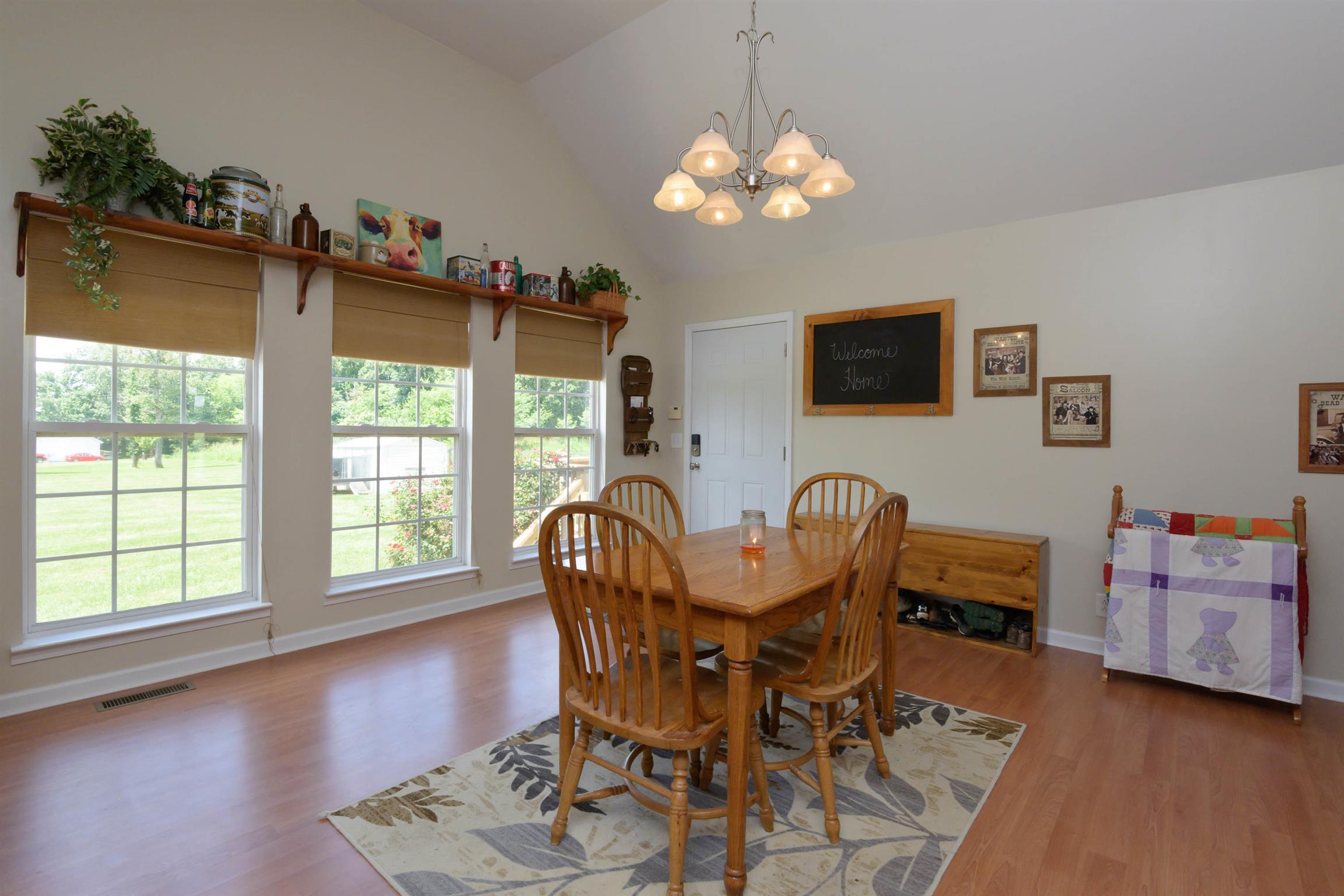 5184 Youngville Road Springfield, TN 37172 - Photo 14 of 29 a dining room with furniture a chandelier and wooden floor
