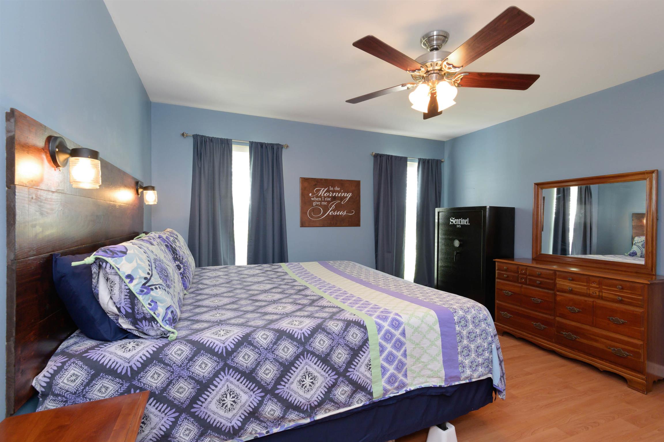 5184 Youngville Road Springfield, TN 37172 - Photo 16 of 29 a bedroom with a large bed and a chandelier