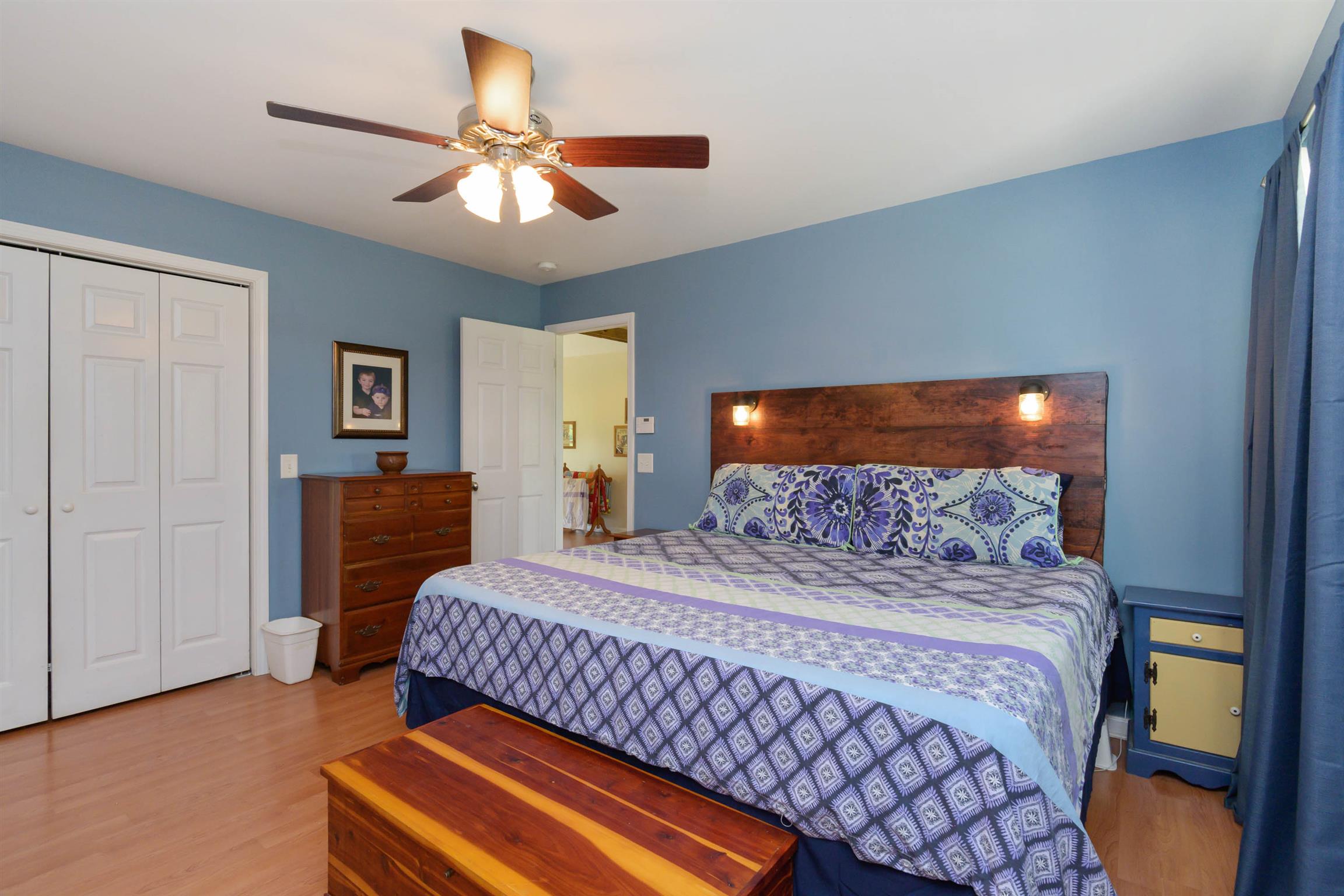 5184 Youngville Road Springfield, TN 37172 - Photo 18 of 29 a bedroom with a bed and a chandelier