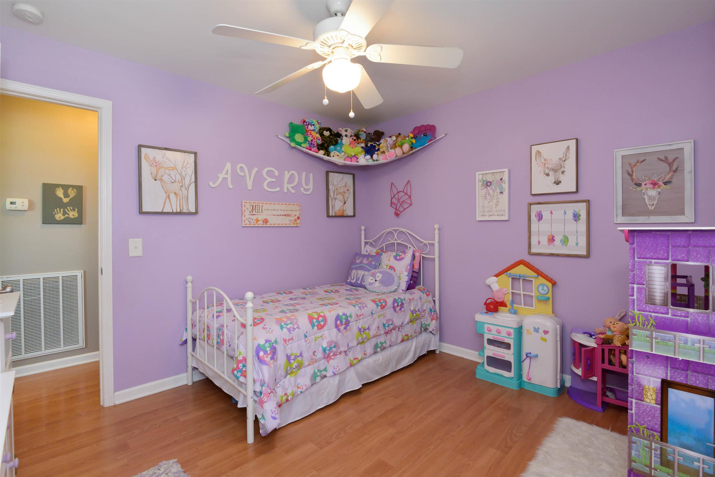 5184 Youngville Road Springfield, TN 37172 - Photo 24 of 29 a bedroom with a bed and a chandelier