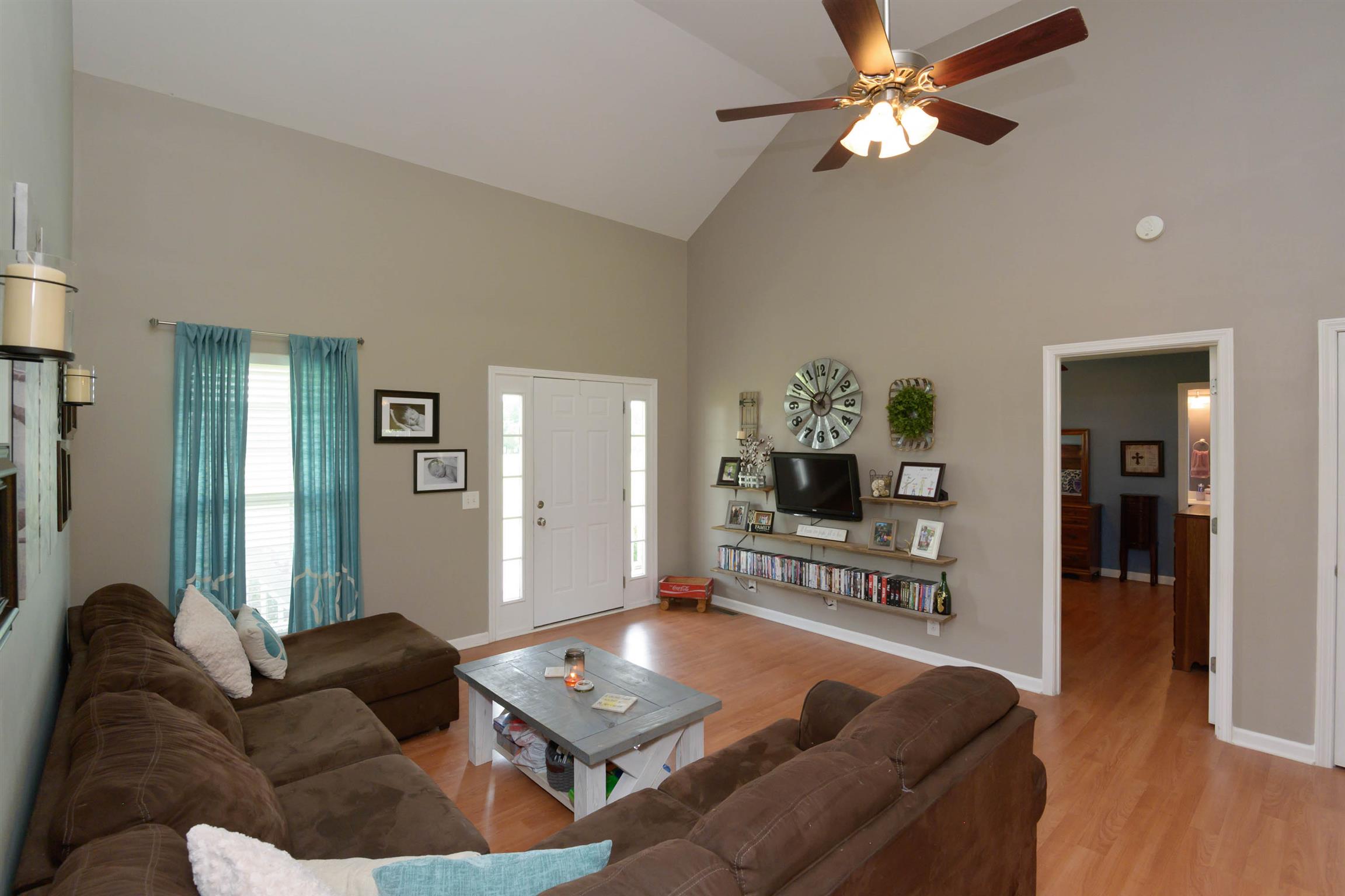 5184 Youngville Road Springfield, TN 37172 - Photo 8 of 29 a living room with furniture a fireplace and a chandelier