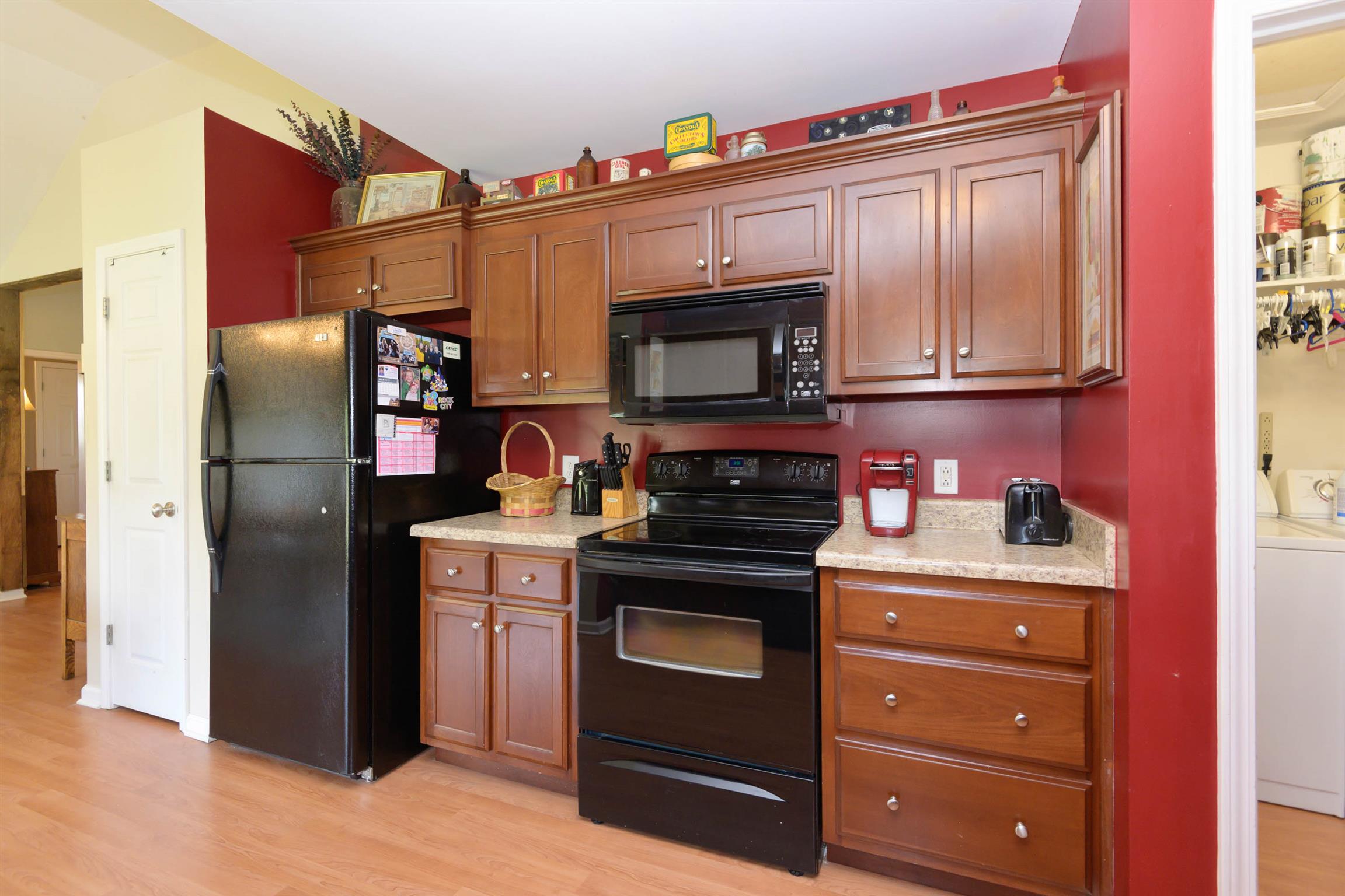5184 Youngville Road Springfield, TN 37172 - Photo 10 of 29 a kitchen with stainless steel appliances granite countertop a refrigerator and a stove top oven