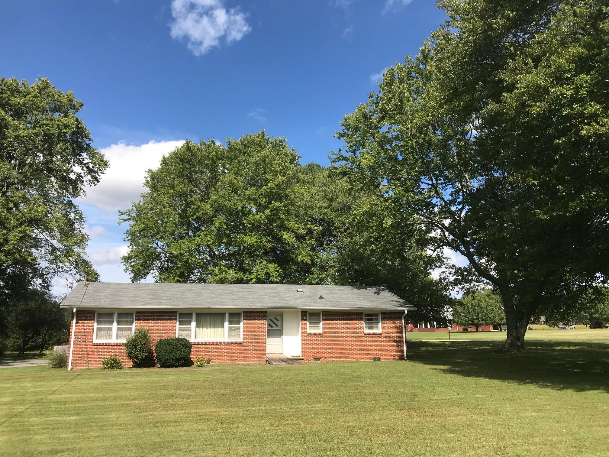 413 Shelton Road Manchester, TN 37355 - Photo 18 of 18 a front view of a house with garden space and trees