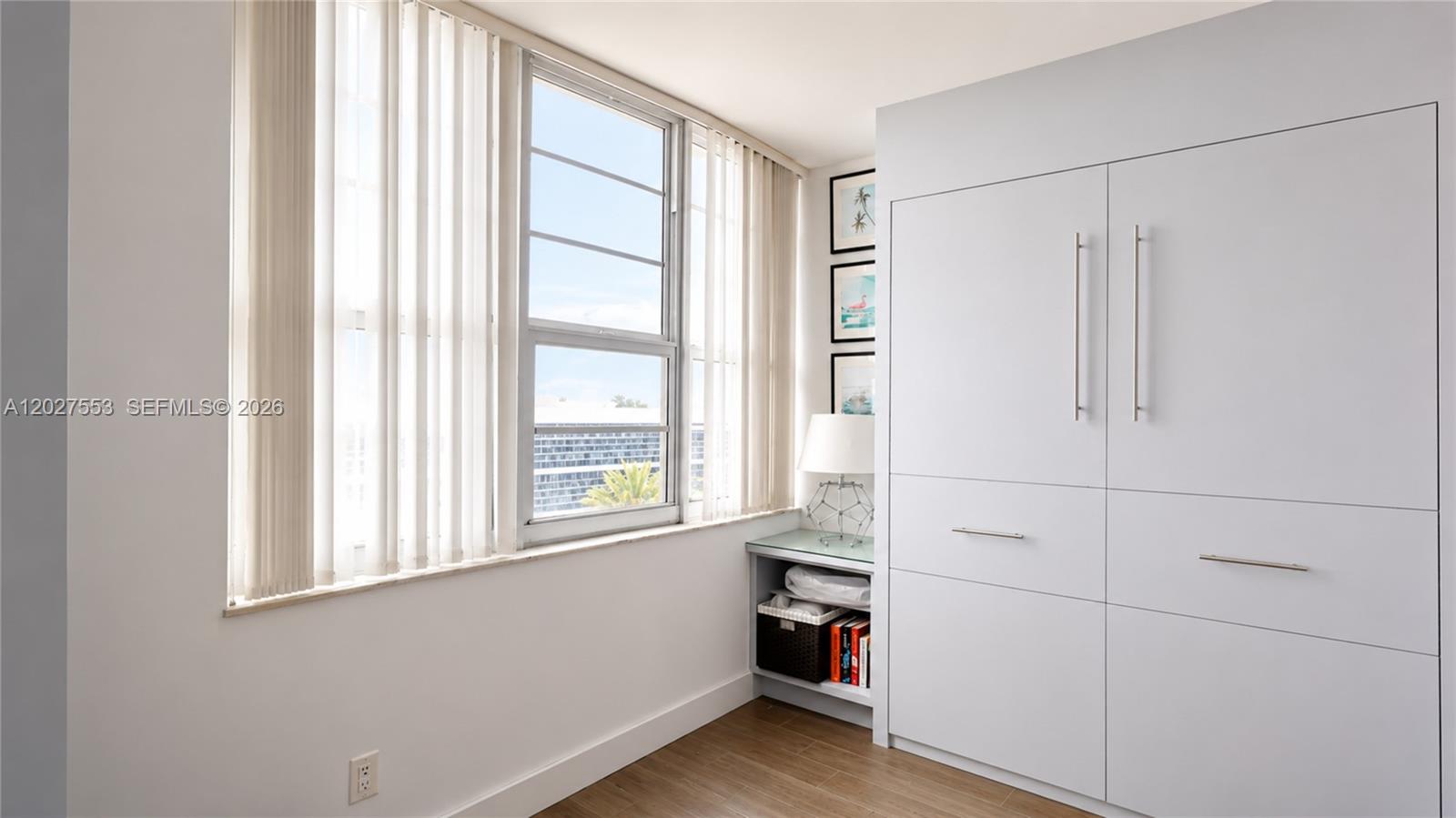 100 Lincoln Road, Unit 533 Miami Beach, FL 33139 - Photo 18 of 26 a view of an empty room with wooden floor and a window