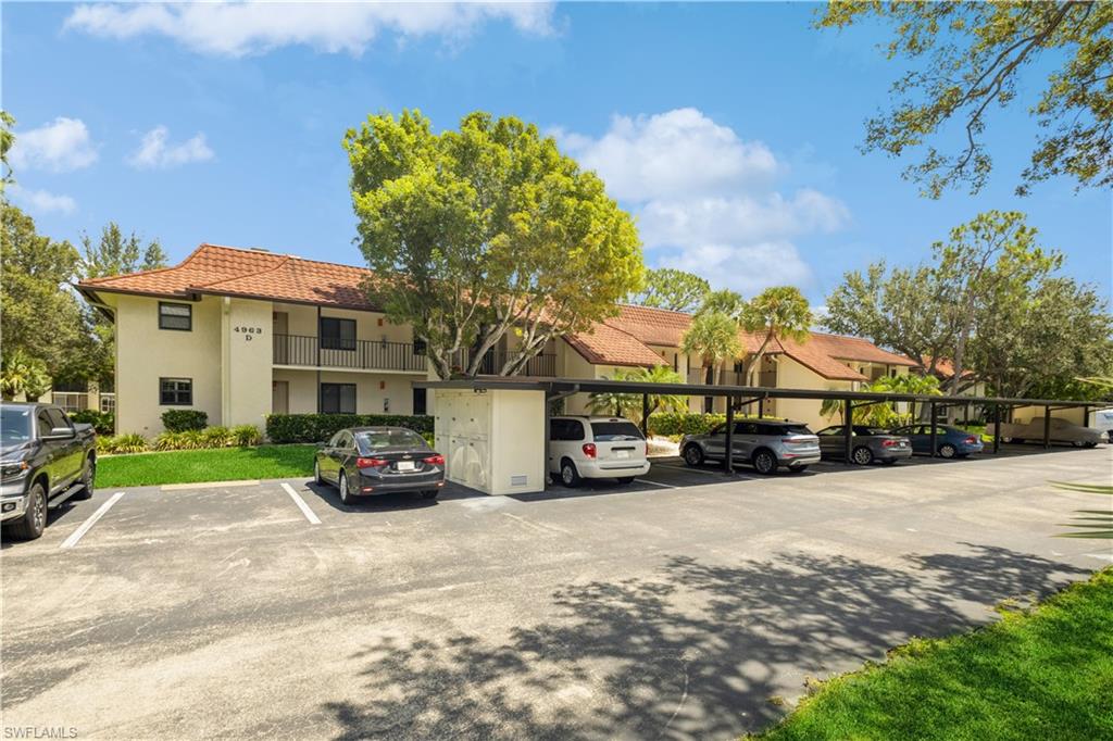 4963 Pepper Circle, Unit D202 Naples, FL 34113 - Photo 1 of 17 a car parked in front of a house