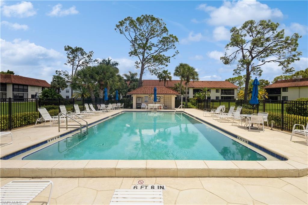 4963 Pepper Circle, Unit D202 Naples, FL 34113 - Photo 16 of 17 a view of a swimming pool with a patio