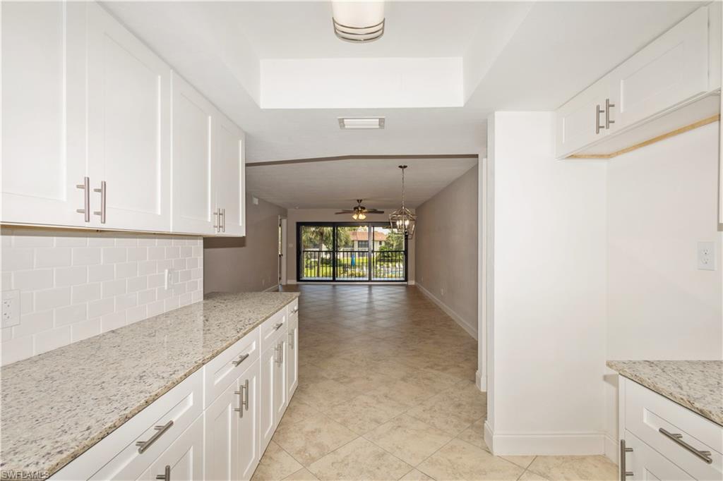 4963 Pepper Circle, Unit D202 Naples, FL 34113 - Photo 6 of 17 a view of a kitchen cabinets and a counter place