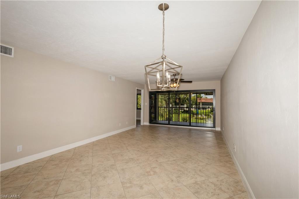 4963 Pepper Circle, Unit D202 Naples, FL 34113 - Photo 7 of 17 a view of a room with a chandelier
