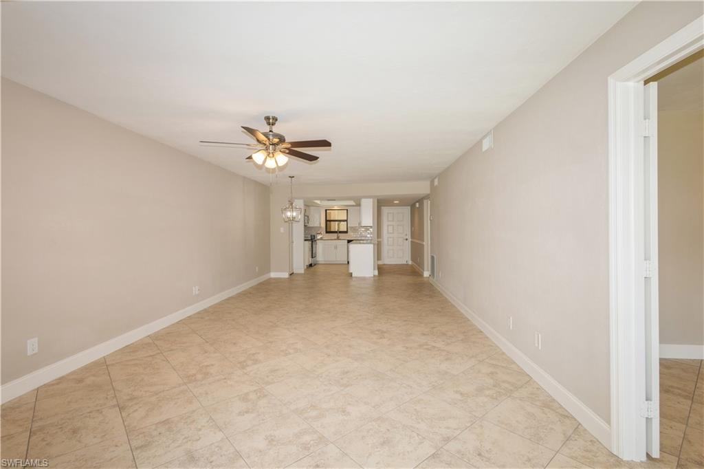 4963 Pepper Circle, Unit D202 Naples, FL 34113 - Photo 8 of 17 a view of a livingroom with a ceiling fan and window