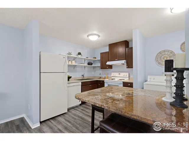 a kitchen with a refrigerator sink and stove