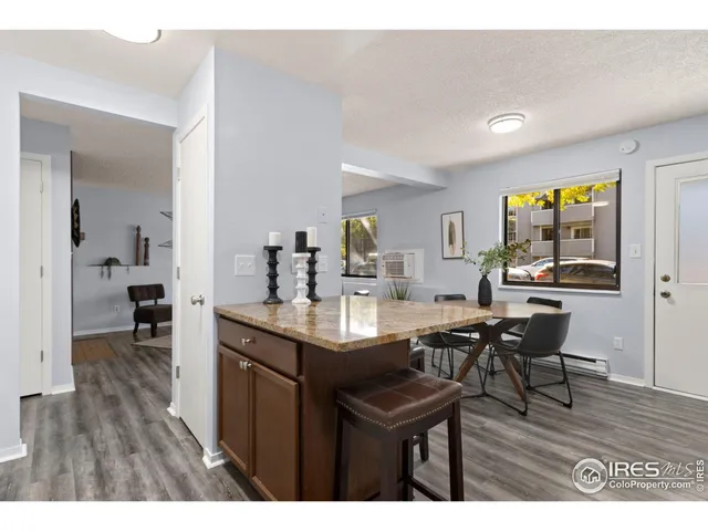 a utility room with a stove and wooden floor