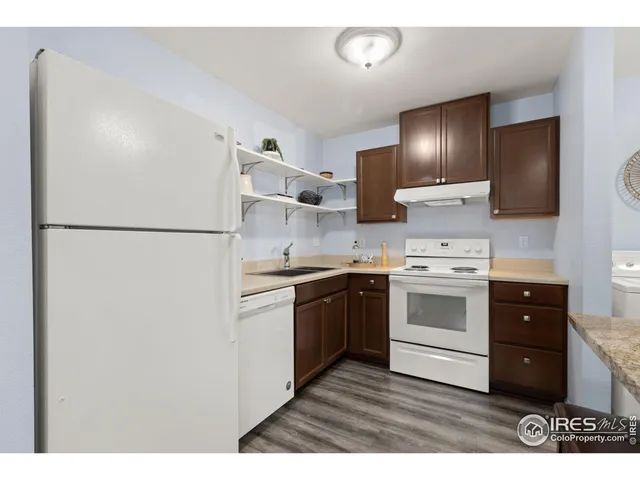 a kitchen with kitchen island a sink appliances and cabinets