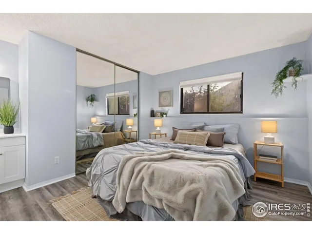 a bedroom with a bed and painting on the wall