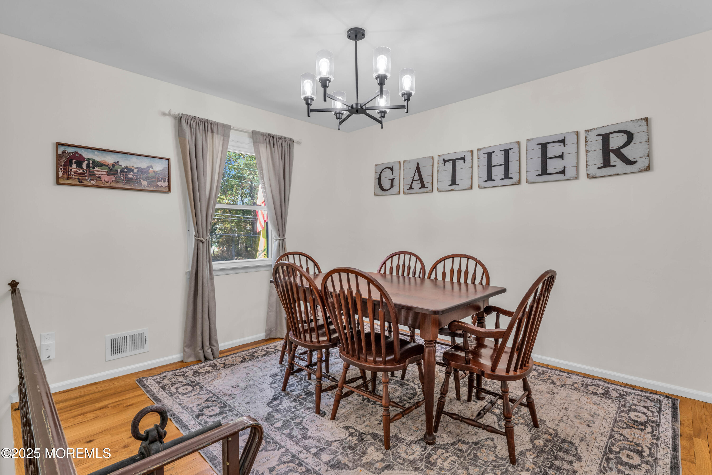 35 Merrick Road Farmingdale, NJ 07727 - Photo 6 of 47 a view of a dining room with furniture a chandelier and wooden floor