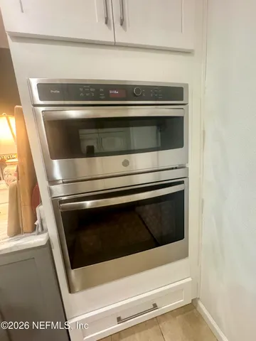 a stove top oven sitting inside of a kitchen