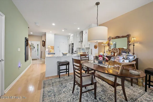 a dining room with furniture and a chandelier