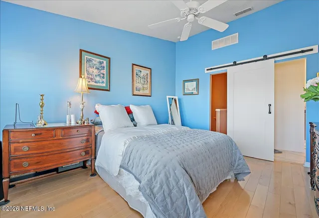 a bed room with a bed and a chandelier