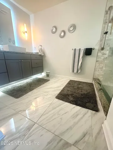 a bathroom with a sink and a mirror