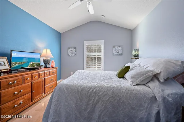 a bedroom with a large bed and a dresser