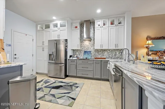 a kitchen with a stove a sink dishwasher a refrigerator and cabinets with wooden floor