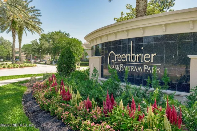 a sign that is in front of flowers