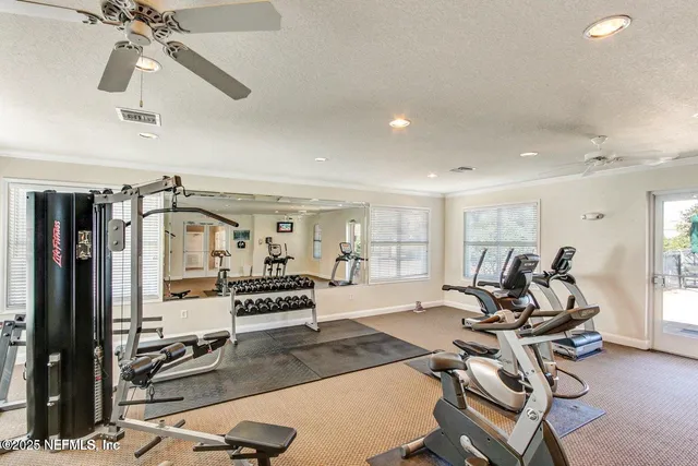 a room with gym equipment and windows