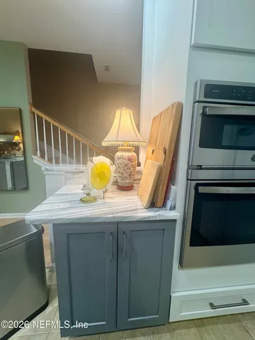 a kitchen with a sink a microwave a refrigerator and cabinets