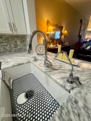 a kitchen with a sink and a stove top oven