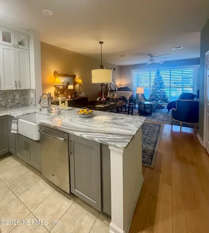 a kitchen with sink stove and chairs