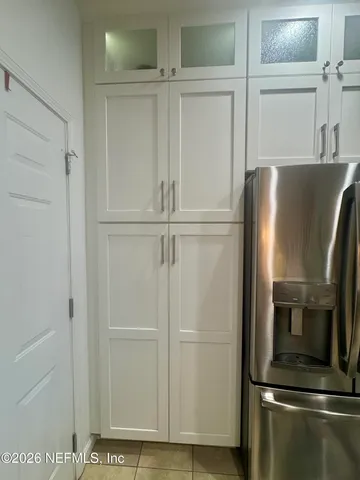 a view of kitchen with stainless steel appliances wooden floor and staircase