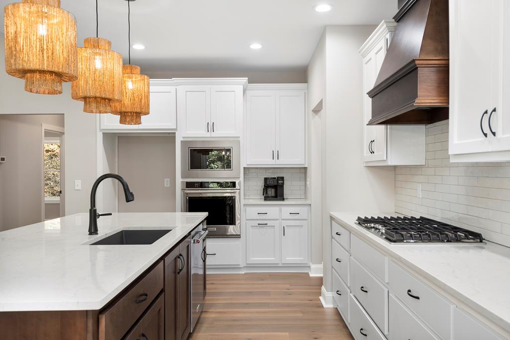 8 Hawks Nest Road Blairsville, GA 30512 - Photo 12 of 30 a kitchen with cabinets a sink a stove and a refrigerator