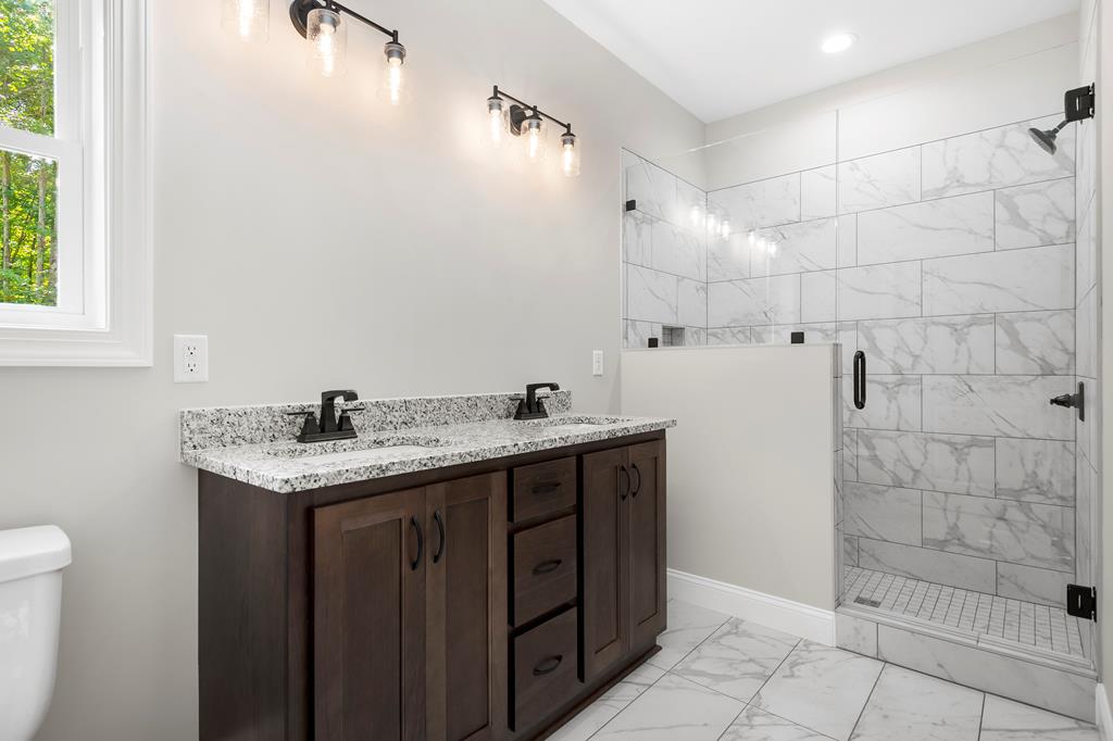 8 Hawks Nest Road Blairsville, GA 30512 - Photo 15 of 30 a bathroom with a granite countertop sink a toilet and shower