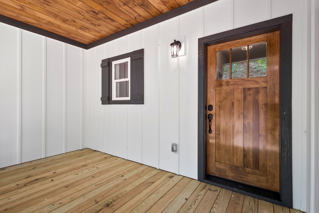 8 Hawks Nest Road Blairsville, GA 30512 - Photo 20 of 30 a view of an empty room with wooden floor and a window