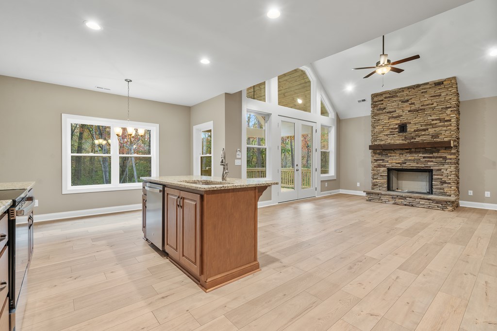 8 Hawks Nest Road Blairsville, GA 30512 - Photo 24 of 30 an open kitchen with fireplace cabinet and windows