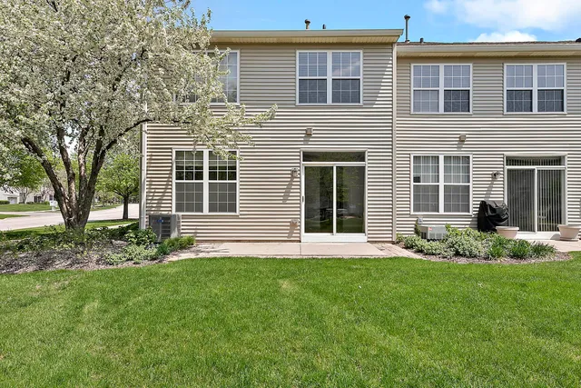a front view of a house with a garden and yard