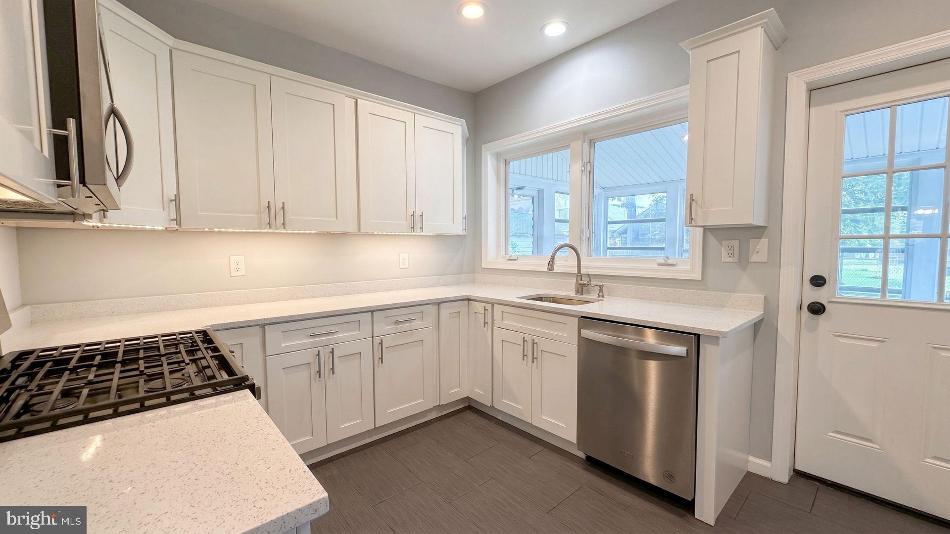 154 Andrew Street Hamilton, NJ 08610 - Photo 9 of 29 a kitchen with a sink stove and cabinets