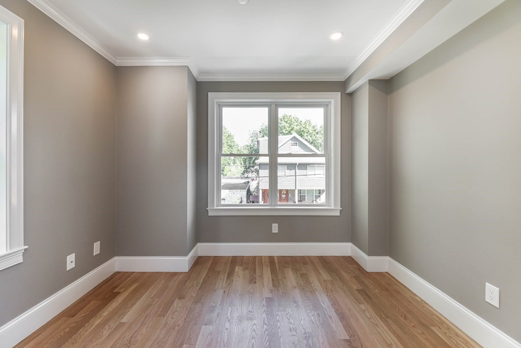 34 Colgate Road, Unit 2 Boston, MA 02131 - Photo 13 of 19 an empty room with wooden floor and windows