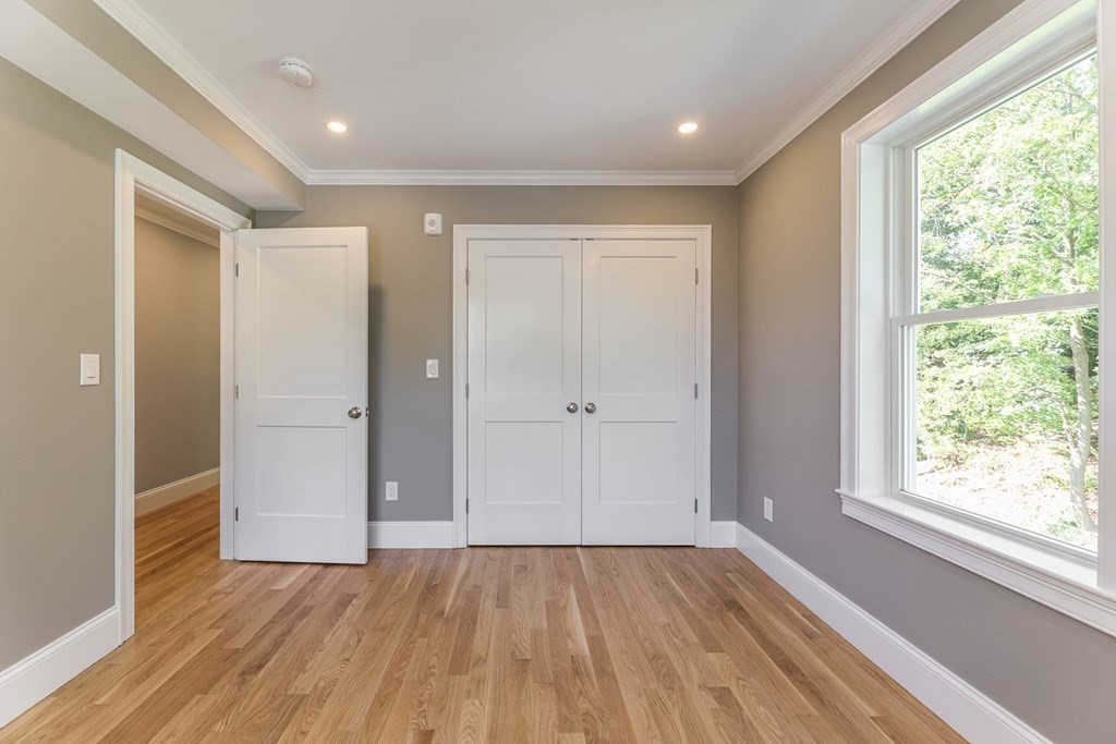 34 Colgate Road, Unit 2 Boston, MA 02131 - Photo 14 of 19 a view of an empty room with wooden floor and a window