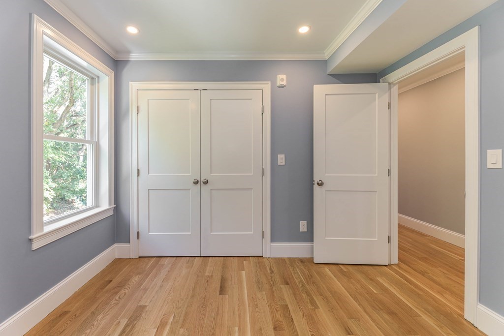 34 Colgate Road, Unit 2 Boston, MA 02131 - Photo 15 of 19 a view of an empty room with wooden floor and a window