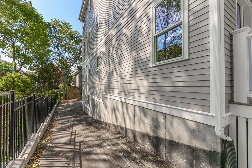34 Colgate Road, Unit 2 Boston, MA 02131 - Photo 19 of 19 a view of a pathway of a brick house with wooden fence