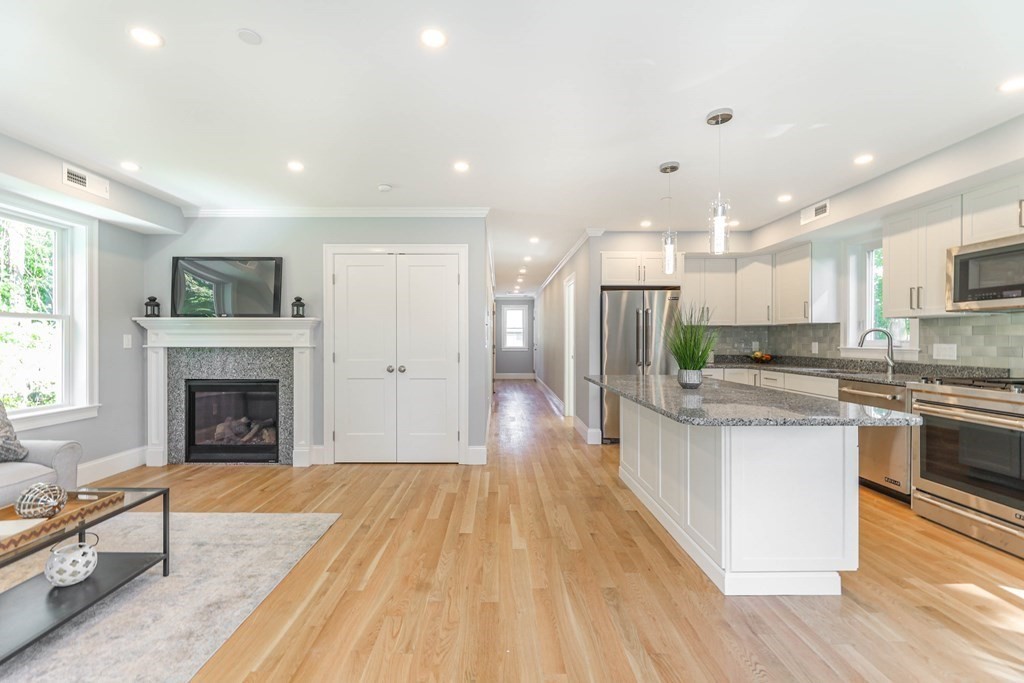 34 Colgate Road, Unit 2 Boston, MA 02131 - Photo 3 of 19 a view of kitchen with kitchen island wooden floor and stainless steel appliances