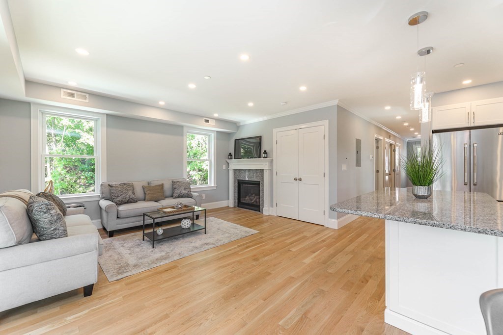 34 Colgate Road, Unit 2 Boston, MA 02131 - Photo 4 of 19 a living room with furniture a large window and a fireplace